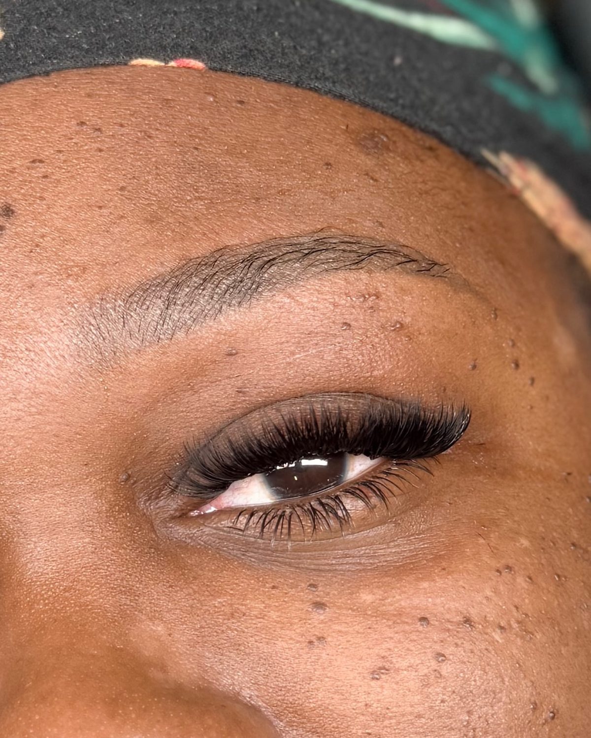 Close-up of a client's full volume lashes paired with bottom lashes